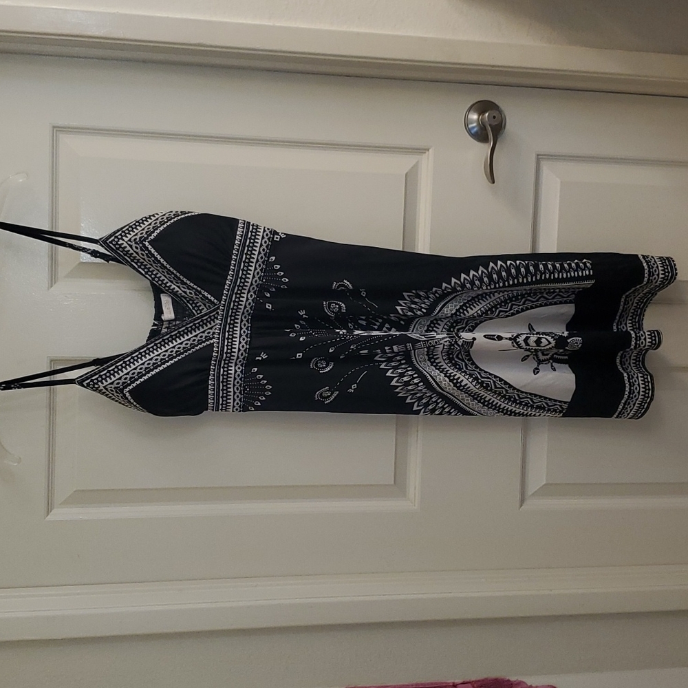 Black dress with white design adjustable shoulder and padded area for breast